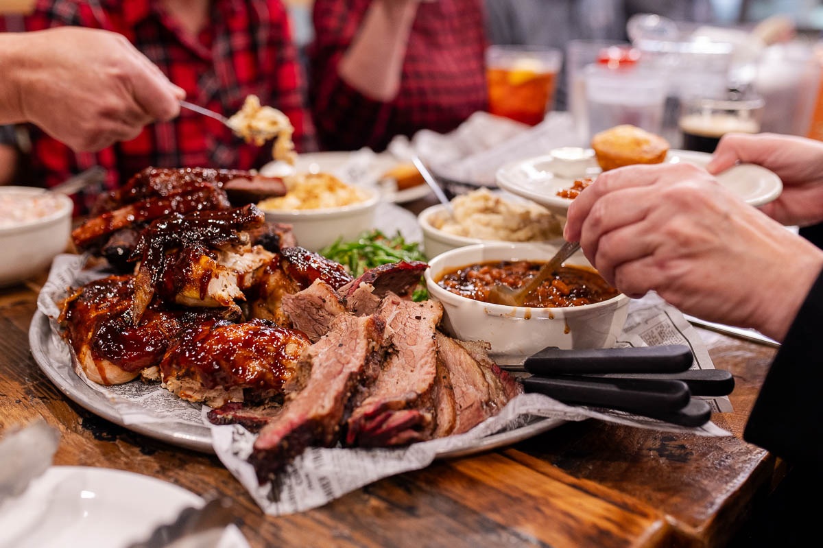 Barbecue and sides shared around a table